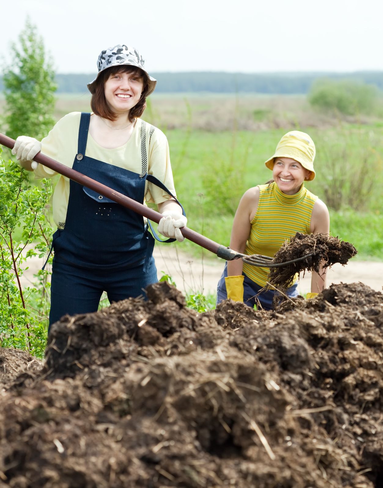 Woman Shoveling Compost